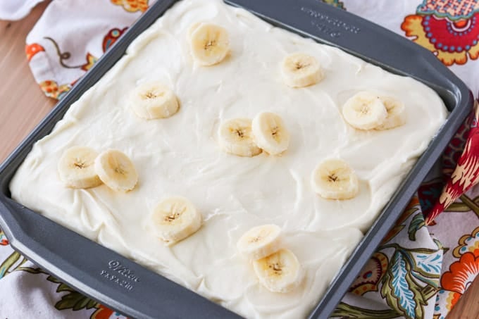 Bananas on top of a frosted cake.