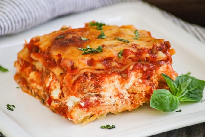 A slice of lasagna on a plate.