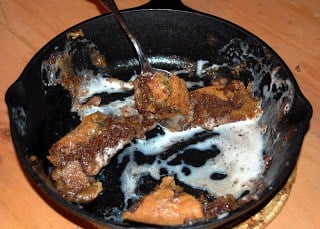 A Chocolate Chip cookie with Vanilla Ice Cream baked in an iron skillet.