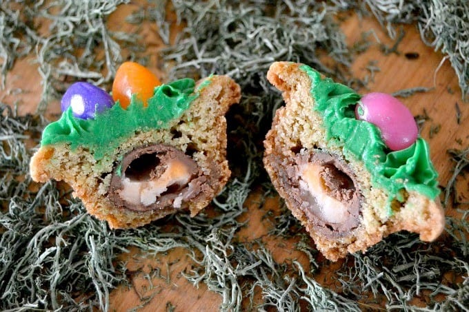 Cookies decorated with green frosting,, jelly beans and a hidden surprise inside - a Mini Cadbury Creme Egg! The perfect Easter treat!