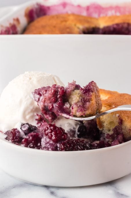 A bite of a cobbler made with fresh berries.
