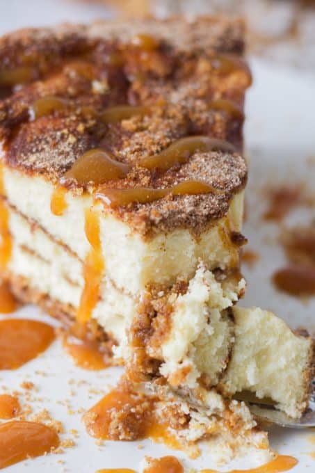 A bite taken out of a Cinnabon Cheesecake