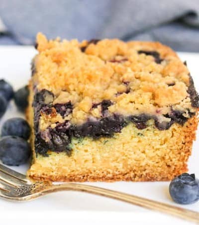 A slice of blueberry cake with crumb topping.