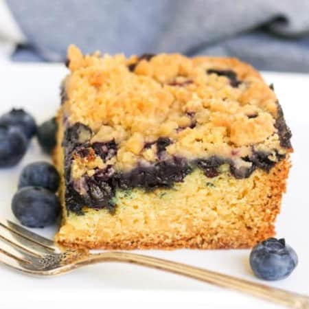 A slice of blueberry cake with crumb topping.