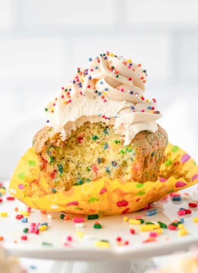 A bite taken out of a Birthday Funfetti Cupcakes