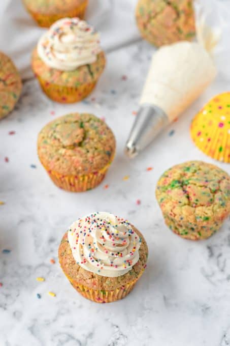 Frosting and cupcakes with sprinkles.