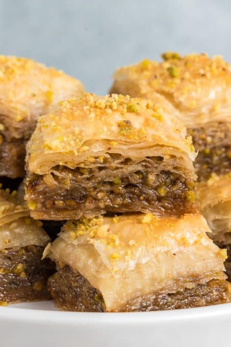 Walnuts and pistachios in between sheets of phyllo dough soaked in a honey syrup.