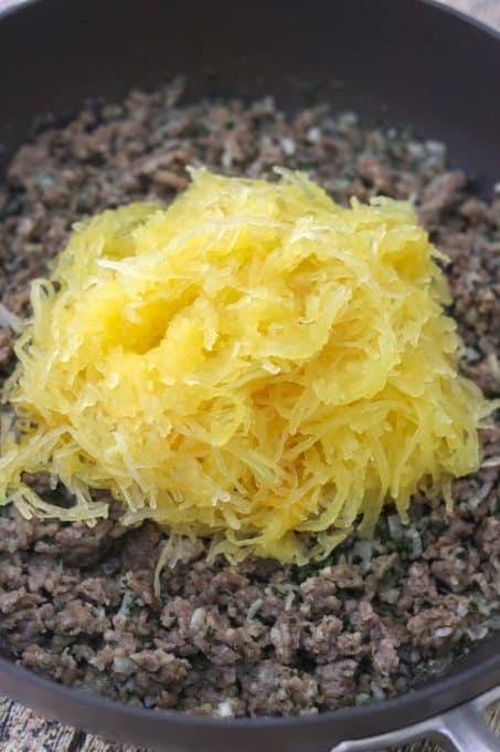 Spaghetti squash on top of ground sausage.