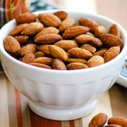 Bowl of Baked Spiced Almonds in a small white bowl.