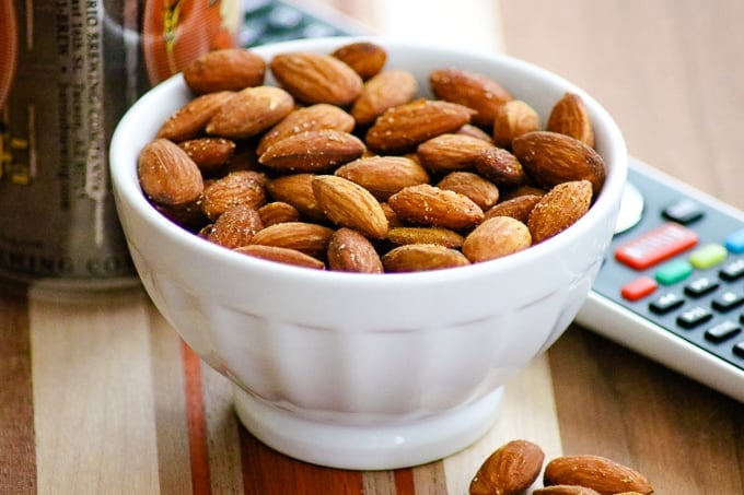 Bowl of Baked Spiced Almonds in a small white bowl.