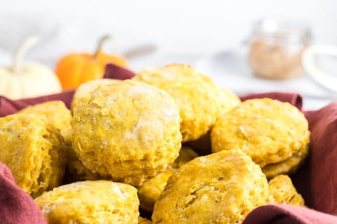 A basket of homemade biscuits made with pumpkin puree.