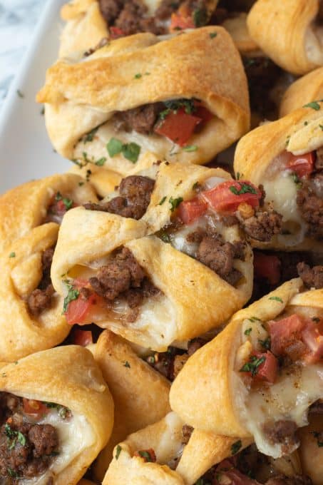 Taco meat, cheese, and tomatoes baked in crescent dough pockets.