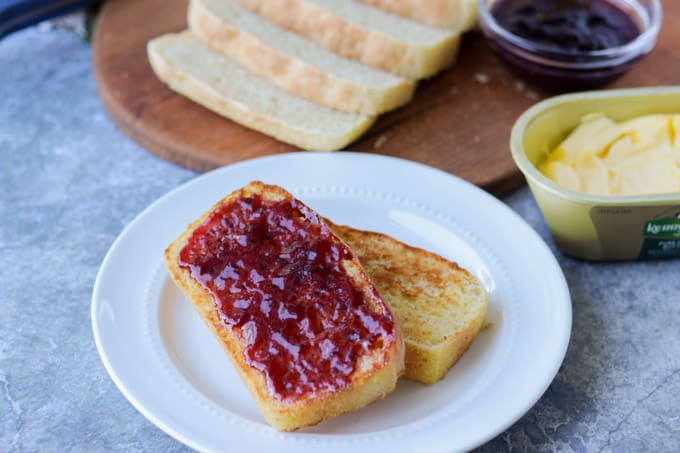 Slices of bread with jam on a plate.