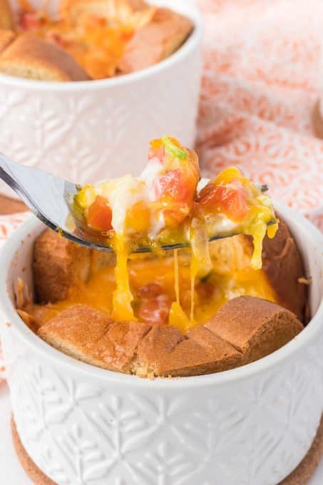 The first forkful of a baked egg in toast.