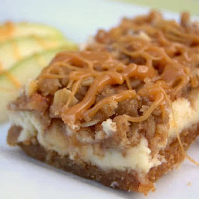 Caramel Apple Cheesecake Bars - cheesecake over a graham cracker crust covered with cinnamon apples, a streusel topping and drizzled with sweet caramel. 