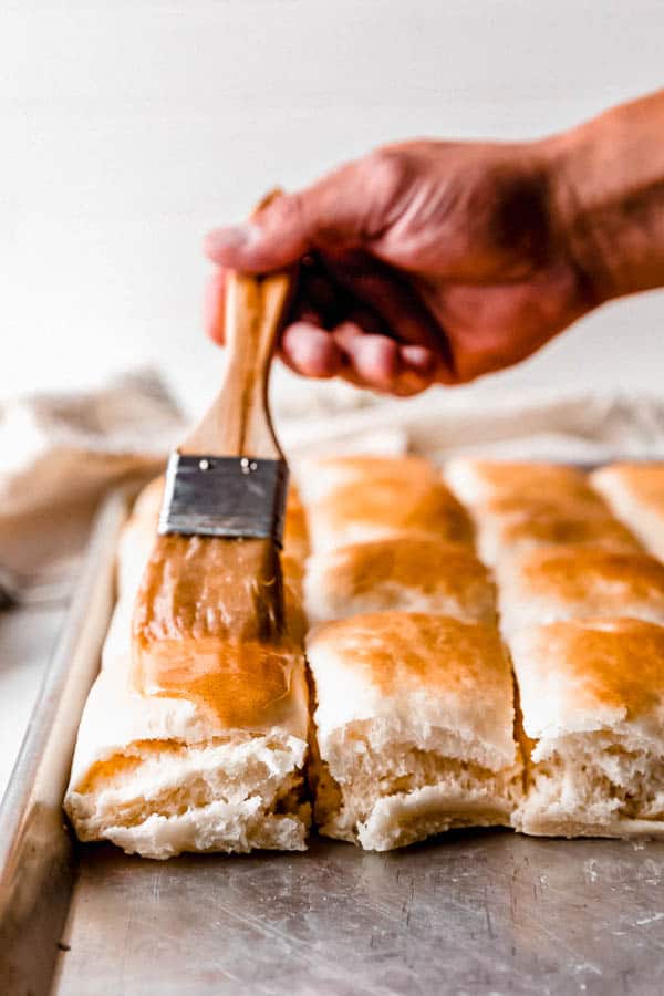 Copycat Texas Roadhouse Rolls brushed with butter.