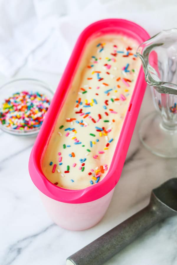 Ice cream with sprinkles in its' container.