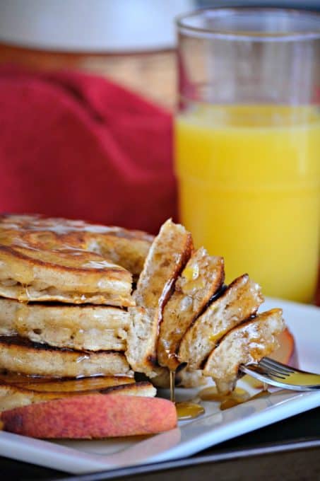 These Cinnamon Peach Pancakes are fluffy buttermilk pancakes spiced with cinnamon and flavored with fresh peaches - a great summer breakfast!