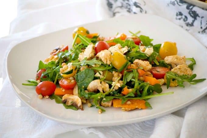 This delicious and easy Couscous Chicken Salad is made with pearl couscous, chicken, lots of veggies, and a bunch of flavor! It's great to eat warm for dinner and again the next day cold for lunch.