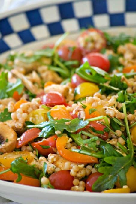 This delicious and easy Couscous Chicken Salad is made with pearl couscous, chicken, lots of veggies, and a bunch of flavor! It's great to eat warm for dinner and again the next day cold for lunch.