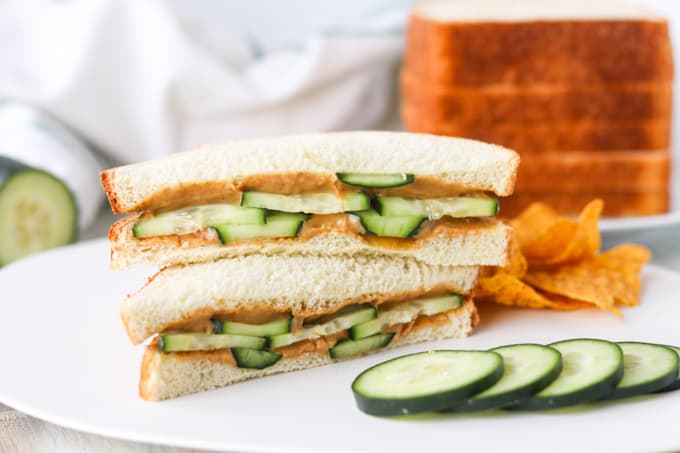 A sandwich with peanut butter and cucumber slices.