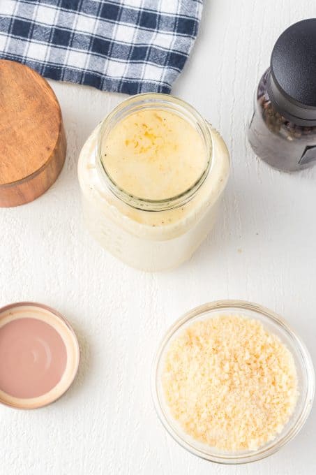 A mason jar full of homemade Alfredo Sauce.