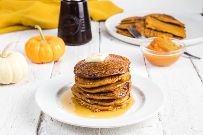 a stack of pancakes with butter and maple syrup.