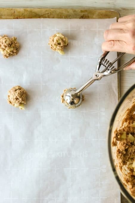 Putting cookie dough on a cookie sheet.