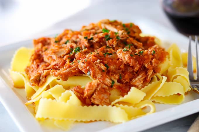 A plate of Crockpot Pork Ragu over some Pappardelle noodles.