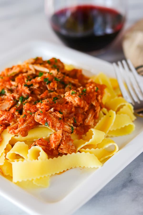 Crockpot Pork Ragu served on top of noodles.