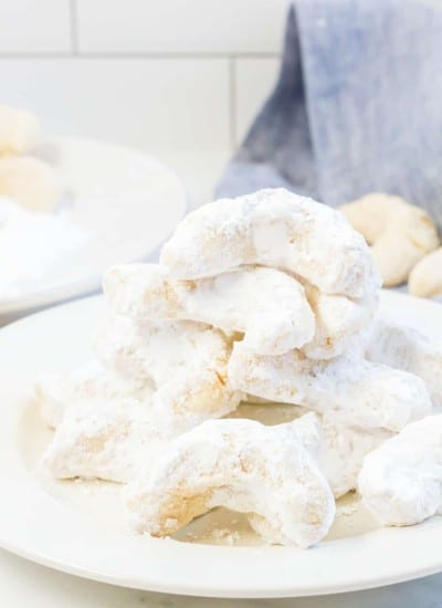 A plate full of almond crescents.