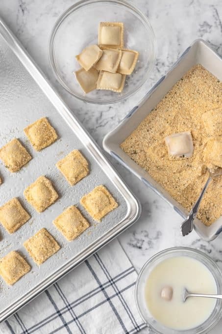 Coating ravioli in buttermilk and then in breadcrumbs and cornmeal.