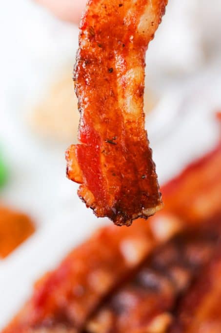 A slice of candied bacon with cajun spices.