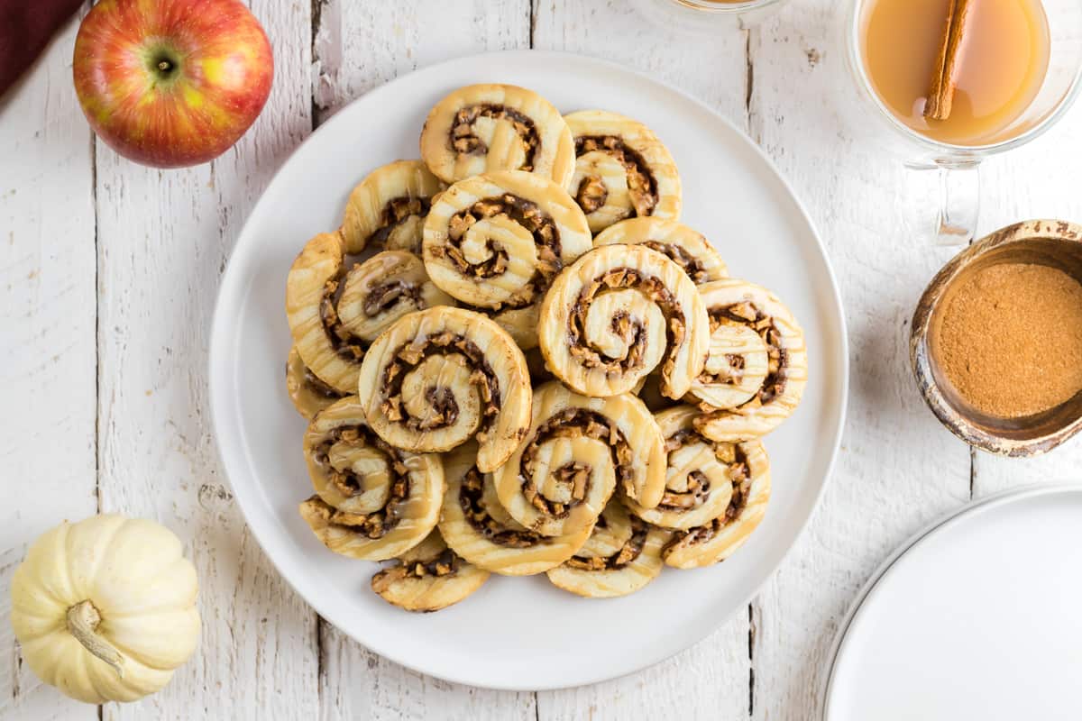 A plate of cookies with caramel and apple pieces.