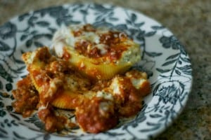 Pasta shells stuffed with a combination of ricotta, parmesan and mozzarella cheeses, topped with a meat sauce and more mozzarella.
