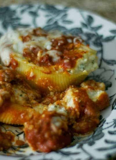 Pasta shells stuffed with a combination of ricotta, parmesan and mozzarella cheeses, topped with a meat sauce and more mozzarella.