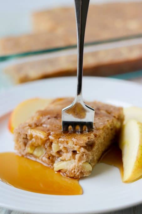 Taking a bite of a baked pancake with apples.