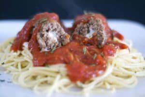 Meatballs made with onion and garlic, breadcrumbs, Parmesan and Romano cheeses, basil, oregano, onion and filled with a cube of mozzarella cheese to give your family or guests a tasty surprise as they cut into it.
