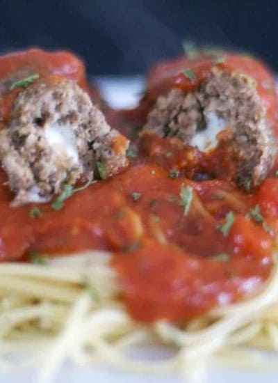 Meatballs made with onion and garlic, breadcrumbs, Parmesan and Romano cheeses, basil, oregano, onion and filled with a cube of mozzarella cheese to give your family or guests a tasty surprise as they cut into it.