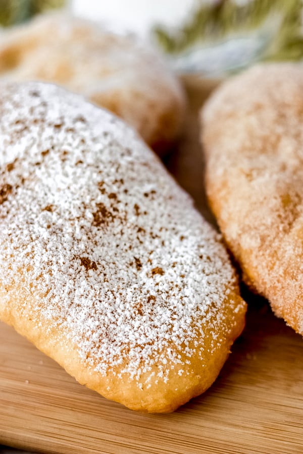 Powdered Sugar and cinnamon on a doughboy or Fried Dough.