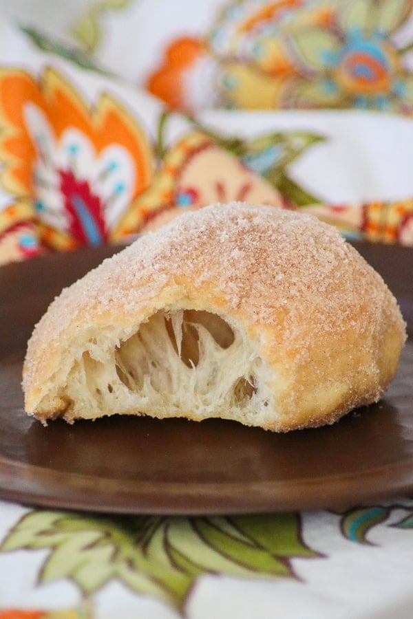 A doughboy or Fried Dough on a plate.