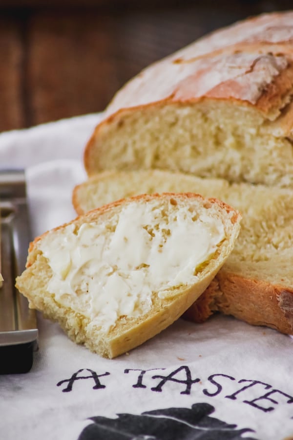 A buttered slice of Grandma's Italian Bread.