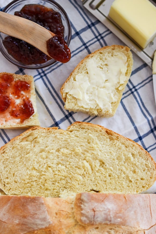 Jam, butter and Grandma's Italian Bread on a napkin.