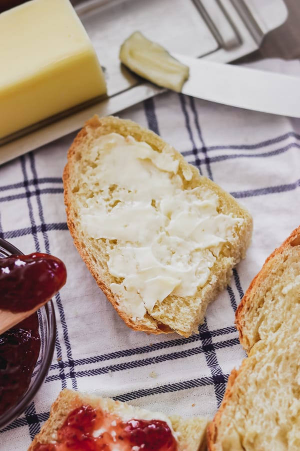 A slice of Grandma's Italian Bread with butter and some jam.