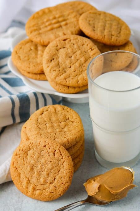 Peanut Butter Cookies made with just 3 ingredients, a glass of milk, and a spoonful of peanut butter.