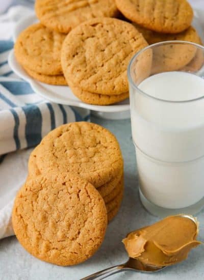 Peanut Butter Cookies made with just 3 ingredients, a glass of milk, and a spoonful of peanut butter.