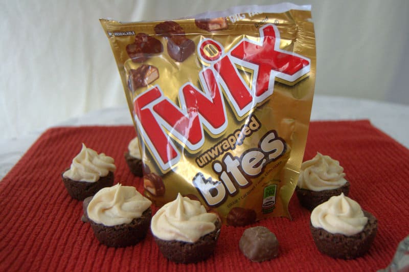 TWIX® Bites Brownies with Chocolate Caramel Buttercream Frosting - bite-sized brownies, each with a TWIX® Bite in the middle and covered with a Chocolate Caramel Buttercream Frosting. 