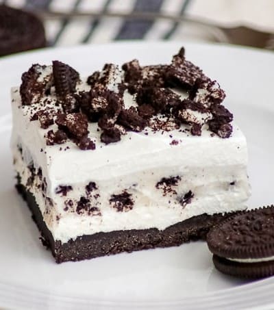 Oreo Pudding Dream Bars or Cookies and Cream Bars on a plate with an Oreo cookie.