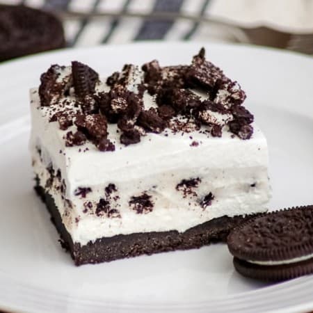 Oreo Pudding Dream Bars or Cookies and Cream Bars on a plate with an Oreo cookie.