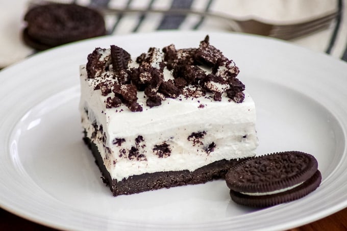 Oreo Pudding Dream Bars or Cookies and Cream Bars on a plate with an Oreo cookie.